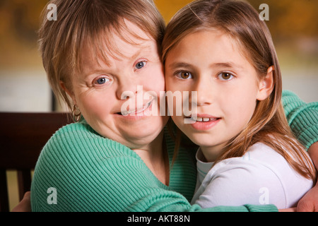 Two girls hugging outdoors Stock Photo - Alamy