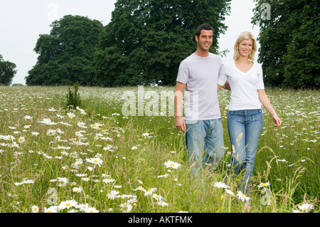 Couple walking through countryside Stock Photo