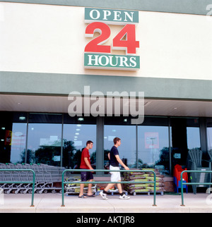 Sobeys supermarket Open 24 Hours sign and young men at the entrance outside exterior  Fort Erie Ontario Canada  KATHY DEWITT Stock Photo