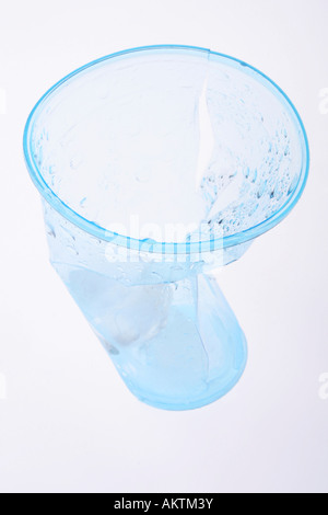 Clear blue plastic cup crumbled and broken Stock Photo