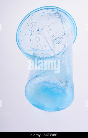 Clear blue plastic cup crumbled and broken Stock Photo