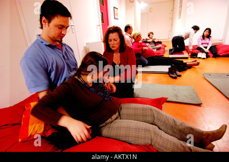 Amsterdam a group of pregnant women is taking part in a yoga course together with their husbands and fathers to be Stock Photo
