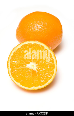 Oranges whole and halved isolated on a white studio background. Stock Photo