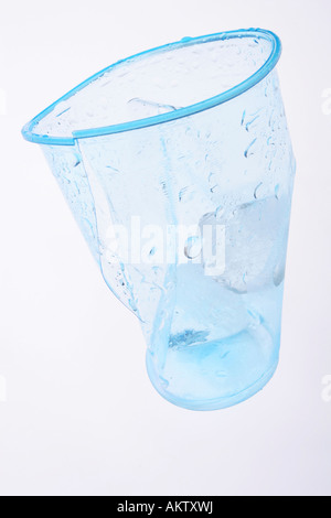 Clear blue plastic cup crumbled and broken Stock Photo