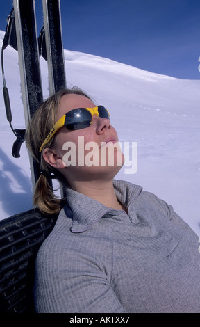 Female skier sunbathing Stock Photo