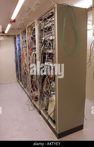 chaotic mess of network cables in a network routing room Stock Photo