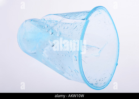 Clear blue plastic cup crumbled and broken Stock Photo