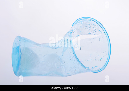 Clear blue plastic cup crumbled and broken Stock Photo