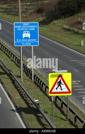 Road signs for High occupancy vehicle lane and pedestrian crossing Leeds England Stock Photo