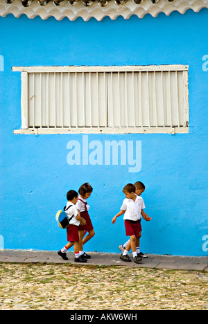 Cuban school children walk together between lessons on the cobbled streets of Trinidad de Cuba Stock Photo