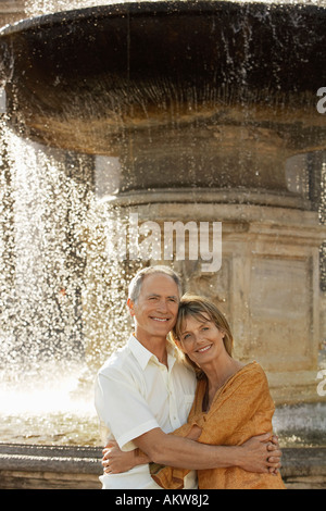 Middle-aged couple hugging by fountain, Rome, Italy, portrait Stock Photo