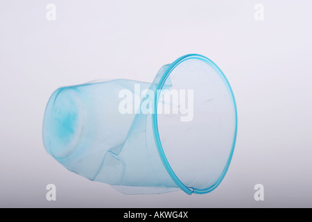 Clear blue plastic cup crumbled and broken Stock Photo