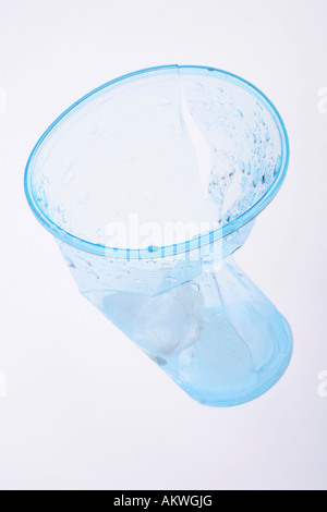 Clear blue plastic cup crumbled and broken Stock Photo