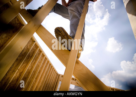 Construction worker working on wood frames house Stock Photo