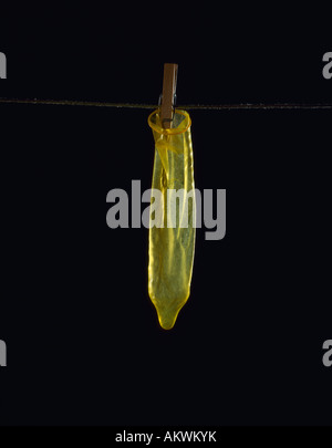 Used Condom on clothesline, close-up Stock Photo
