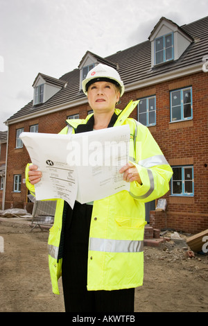 Surveyor inspecting a new development on a house building site, UK Stock Photo