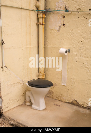 Corner of an old outdoor toilet half demolished with only two walls left standing in Braunton Village Devon England Stock Photo