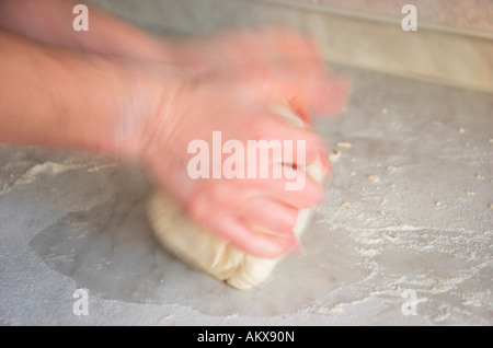 Hands kneading dough blurred motion Stock Photo