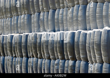 Stacked silage bales wrapped in plastic for a rural biomass gasifier Stock Photo