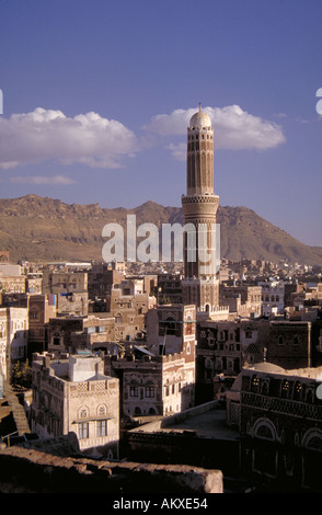 Tall domed minaret tower projecting high above Sana s rooftops Islam Sana Yemen Stock Photo