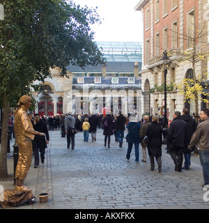 Shoppers avoiding a street performer, Covent Garden, London Stock Photo