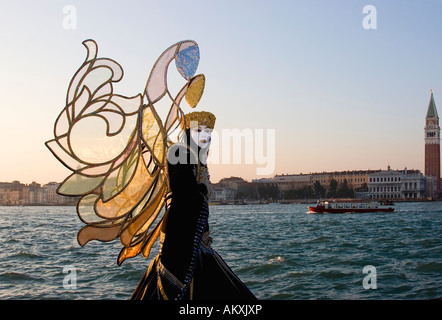Butterfly mask in evening light at the carnival, Venice, Italy Stock Photo