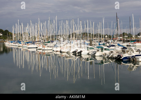 Boats yachts reflected in busy marina La Trinite sur Mer near Carnac Brittany France