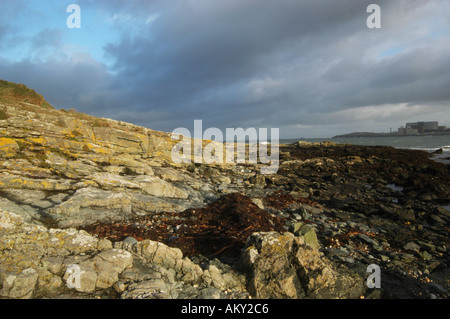 Dramatic sky and lighting at Cemlyn Bay in Anglesey with Wylfa Power Station in the background Stock Photo