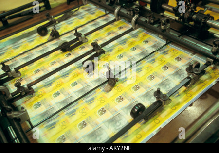 Bank notes passing through numerator, Australia Stock Photo