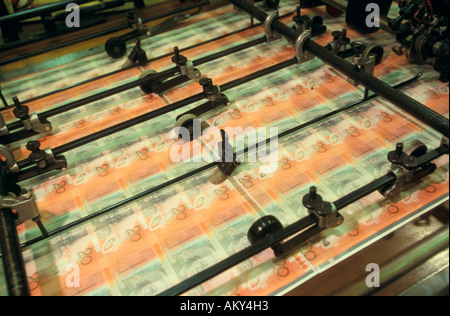 Bank notes passing through numerator, Australia Stock Photo