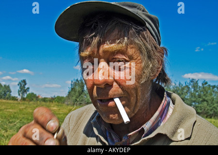 Portraita gray haired farmer smokes a cigarette, Lithuania, Baltic States Stock Photo