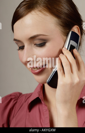 Young woman at the cell phone Stock Photo