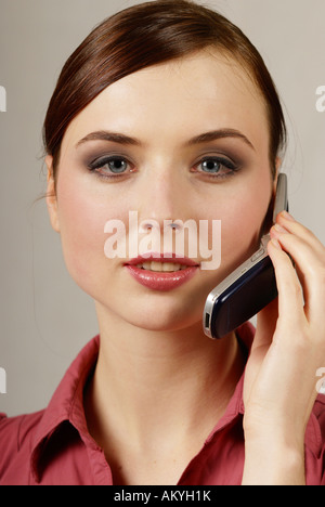 Young woman at the cell phone Stock Photo