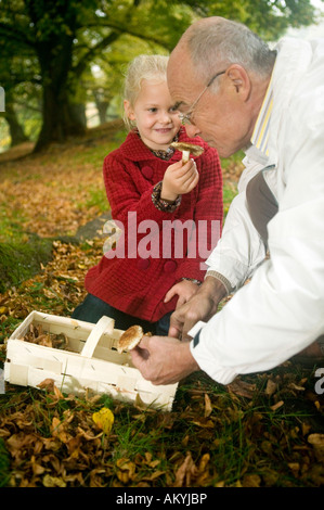 Germany, Baden-Württemberg, Swabian mountains, Grandfather and granddaughter searching mushrooms in the forest, portrait