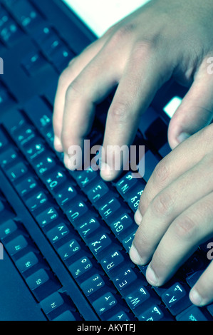 close up of man typing on computer keyboard Stock Photo