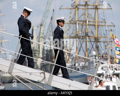 two uniformed officers of the famous Italian tall ship Amerigo Vespucci disembarking in Antwerp Belgium Stock Photo