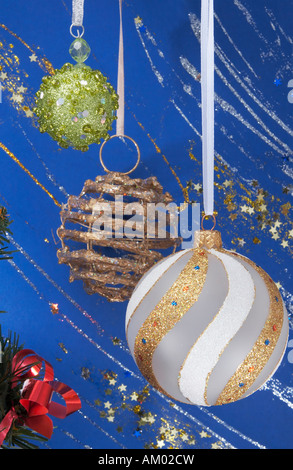 Festive Christmas composition with various hanging holiday balls on blue decorative winter background with sparkles and stars Stock Photo