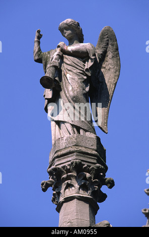 Guardian angel statue atop a mausoleum in Cimetiere de Montmartre, Paris, France. Stock Photo