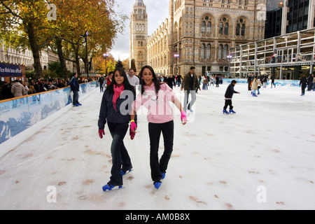 Teens Ice skating in winter, Natural History Museum, London England UK Stock Photo