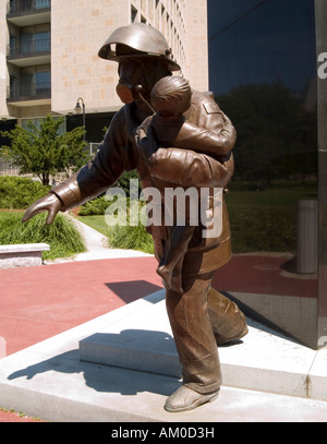 A sculpture of a fire fighter carrying a child, dedicated to all fallen Ontario fire fighters. Situated in Queens Park Toronto Stock Photo