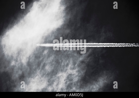 Commercial Airplane Leaving Vapor Trail In The Sky Stock Photo