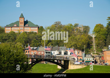 ILLINOIS Galena People walk on pedestrian bridge to Country Fair annual handicrafts event stairs up hillside in background Stock Photo