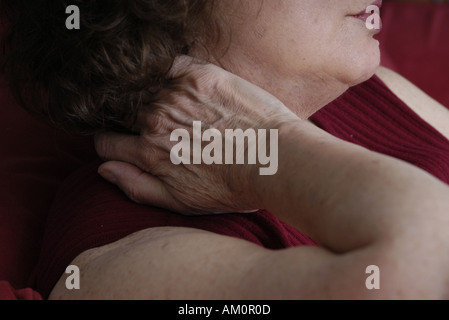 A woman messaging a sore spot on her body. Stock Photo