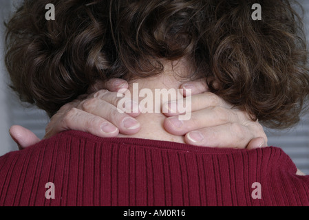 A woman messaging a sore spot on her body. Stock Photo