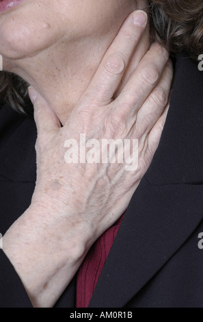 A woman messaging a sore spot on her body. Stock Photo