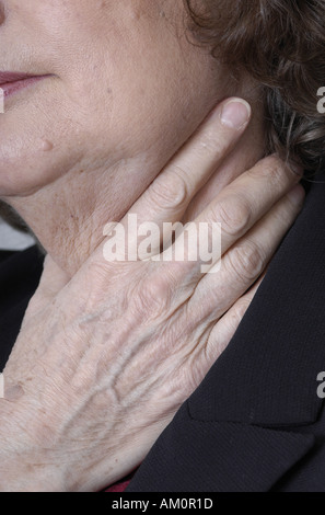 A woman messaging a sore spot on her body. Stock Photo