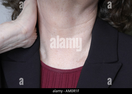 A woman messaging a sore spot on her body. Stock Photo