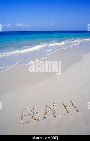 The word BEACH written on the sand on white tropical beach in Playa del Carmen, Cancun, Mexico Stock Photo