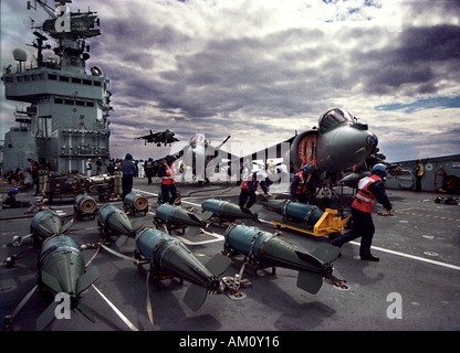 Harrier jump jet landing on the Royal Navy aircraft carrier HMS Illustrious Stock Photo