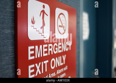 Sign: Emergency Exit Only and No Smoking at a metal gate Stock Photo